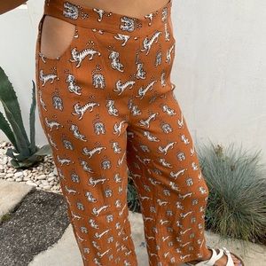 Cut-out flowy lion-patterned pants